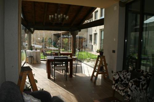 a screened in porch with a table and chairs at La Posada de las Casitas in Ampudia