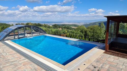 a swimming pool with a view of the mountains at Villa Ozoni - Jezerc in Ferizaj