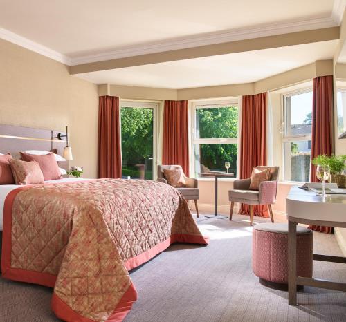 a hotel room with a bed and a desk at Tulfarris Hotel and Golf Resort in Blessington