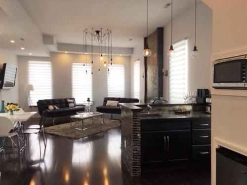 a living room with a kitchen and a living room with a table at Luxury three story apartment in SHORT NORTH in Columbus