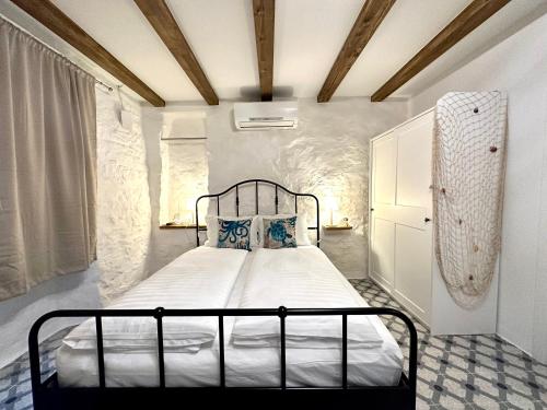 a bedroom with a bed with a metal frame at Apartments Angela in Piran