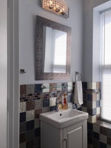 a bathroom with a sink and a mirror at Luxury three story apartment in SHORT NORTH in Columbus