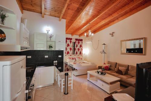 a kitchen and living room with a couch and a table at Villa Matilda in Borsh