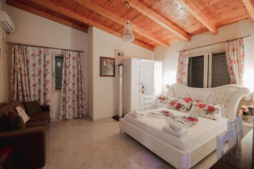 a living room with a white bed and a couch at Villa Matilda in Borsh
