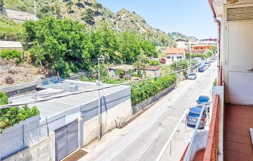 a street with cars parked on the side of a building at 2 Bedroom Awesome Apartment In Messina in Briga Marina