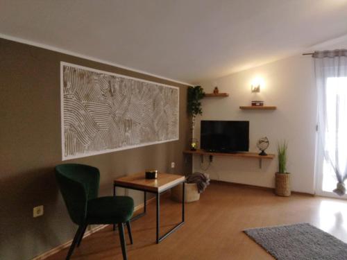 a living room with a table and a television at Apartments Anita Frane in Vodice