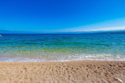 a sandy beach with the ocean in the background at Blue Waves Resort in Malinska