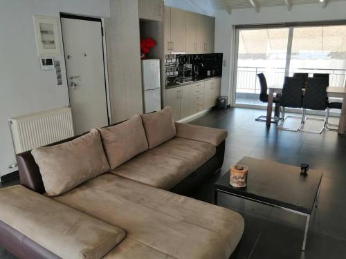 a living room with a couch and a table at Manolis Loft in Piraeus