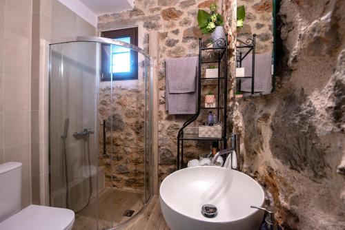 a bathroom with a shower and a toilet and a sink at Lilaia's View in Lílaia
