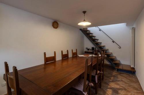 a dining room with a long table and a staircase at Casa Valentina, casa intera vicino al mare in Carrara