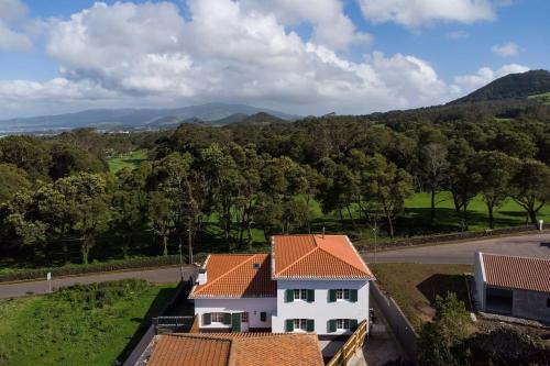 an aerial view of a white house with an orange roof at Batalha Family House in Fenais da Luz