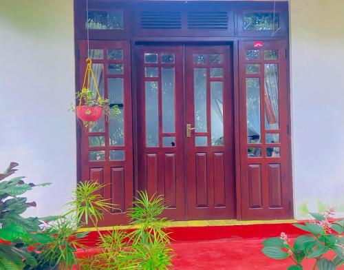 a red door of a house with plants in front at Home Away Ella in Ella