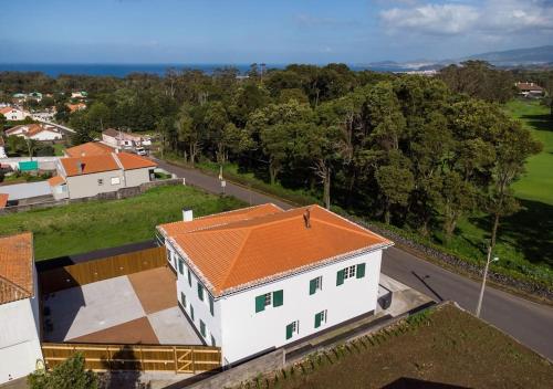 an overhead view of a white house with an orange roof at Batalha Family House in Fenais da Luz