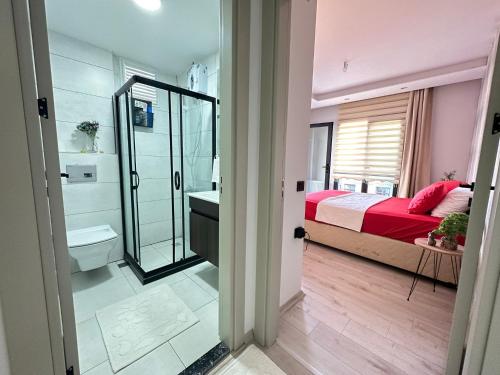 a bedroom with a bed and a sink and a mirror at Beautiful house close to the sea in the center of MERSİN in Mersin