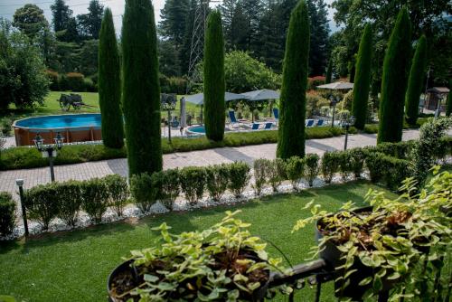 a garden with trees and a swimming pool at Casale al Foino in Induno Olona