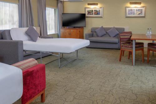 a living room with a couch and a table at The Park Royal Hotel & Spa in Warrington