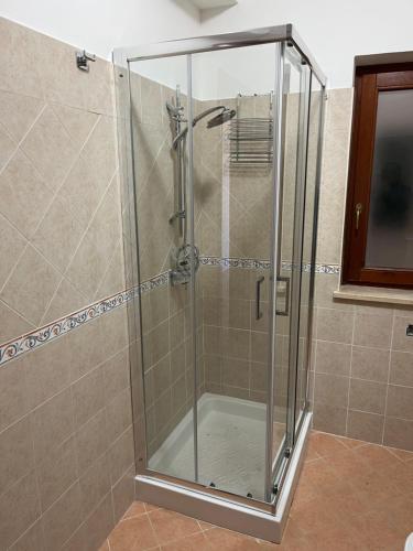 a shower with a glass door in a bathroom at Casa Palma in San Donato