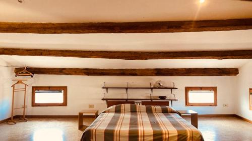 a bedroom with a bed in a room with wooden beams at Cà Sardi in Venice