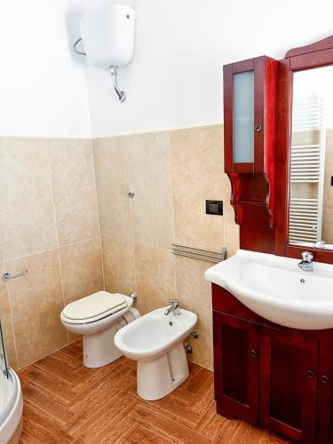 a bathroom with a toilet and a sink at The Apartment Agrigento in Agrigento