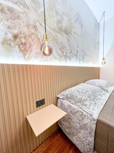 a bedroom with a bed and a table at The Apartment Agrigento in Agrigento
