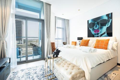 a bedroom with a large bed and a large window at The Suite Dubai 15 Northside Luxury Living in Dubai