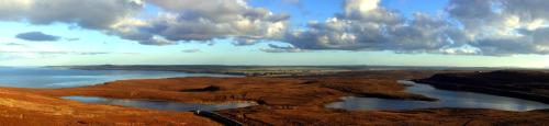 a view of a body of water under a cloudy sky at Craiglea Lodge & Barn in Latheron