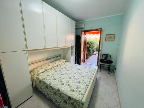 a bedroom with a bed and a door to a hallway at New Residence in Campofelice di Roccella