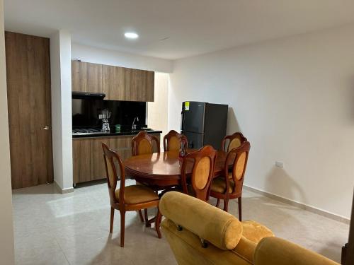 a kitchen and dining room with a table and chairs at Apto-Parking cerca CC Gran Plaza in Pitalito