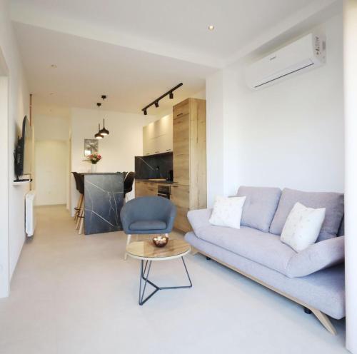 a living room with a couch and a table at Apartments Maestral in Medulin