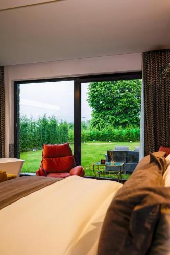 a bedroom with a bed and a large window at Çathan Art Hotel in Ayder Yaylasi