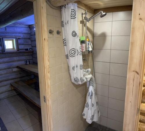 a bathroom with white towels hanging on a wall at Namiņš Guntas in Uguņi