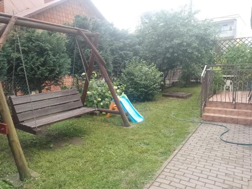a playground with a bench and a slide at Dom na Konwaliowej in Narew