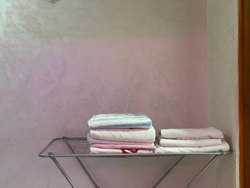 a stack of towels on a shelf against a wall at ELFA APPARTEMENTS Familiaux in Agadir