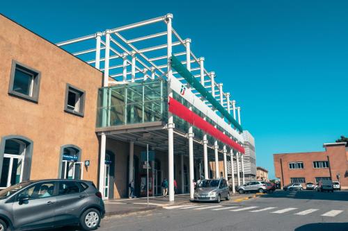 a parking lot with cars parked in front of a building at BluMarine Appartaments in Paola