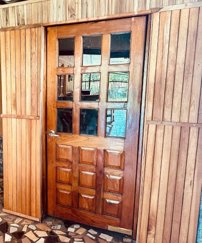 a wooden door in a wooden fence with windows at Residencial Coya in David