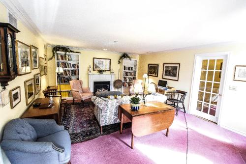 a living room with a couch and a table at Blairpen House Country Inn in Niagara on the Lake