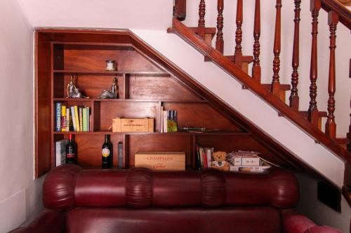 a brown leather couch sitting under a stair case at Nomad Villa Santa Fe in Las Palmas de Gran Canaria