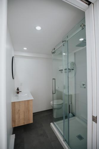 a bathroom with a glass shower and a sink at Station Boréale in Val-dʼOr