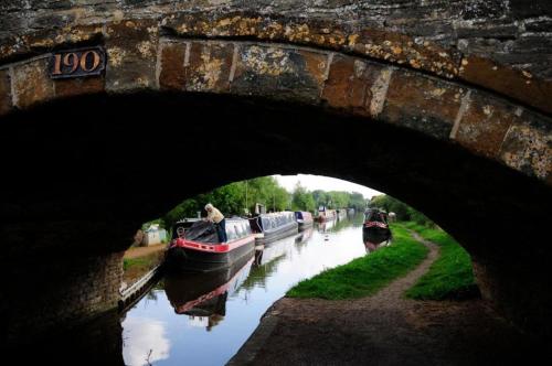 a bridge over a river with boats on it at The Great Western Arms in Clifton Hampton