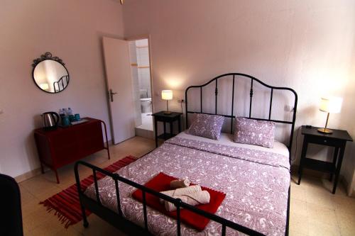 a bedroom with a bed and two tables and a mirror at Nomad Villa Santa Fe in Las Palmas de Gran Canaria