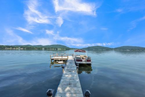 a boat is docked at a dock on a lake at Lakeside Paradise- 4BR Retreat on Neely Henry Lake home 