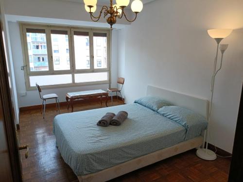 a bedroom with a bed with two brown shoes on it at la maison du centre in Irún