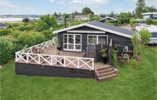 a small house with a deck on the grass at Amazing Home In Kirke Såby With Wifi in Kirke Såby