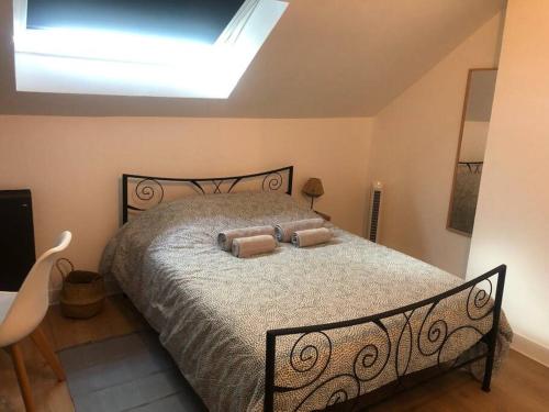 a bedroom with a bed with two pillows on it at Le Domremy F2 au cœur d'Orléans in Orléans