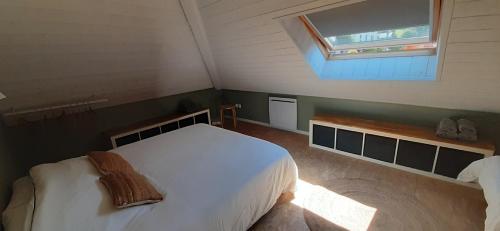 a bedroom with a white bed and a window at LES TERRASSES 1 de VILLARD in Villard-de-Lans