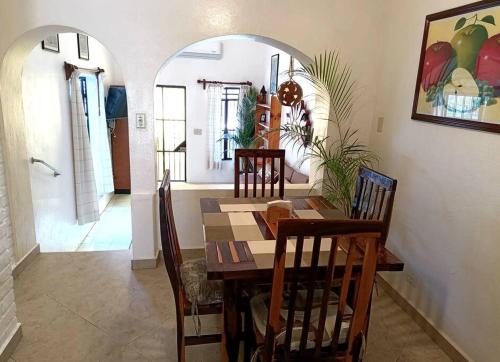 a dining room with a wooden table and chairs at terraza y balcón en la zona romantica cerca del mar in Puerto Vallarta