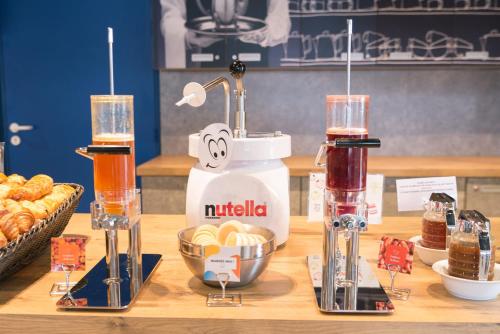 a counter with two blenders and a mixer and some food at ibis budget Rennes Rte Lorient in Rennes