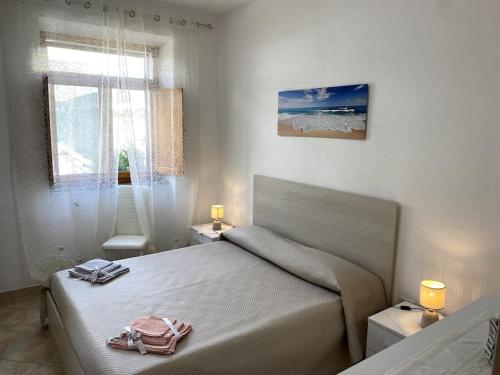Postel nebo postele na pokoji v ubytování La Perla Casa Iside con 2 camere, giardino privato