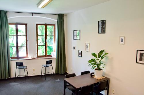 Una habitación con una mesa y sillas y una ventana. en Elephants Apartments, en Bratislava