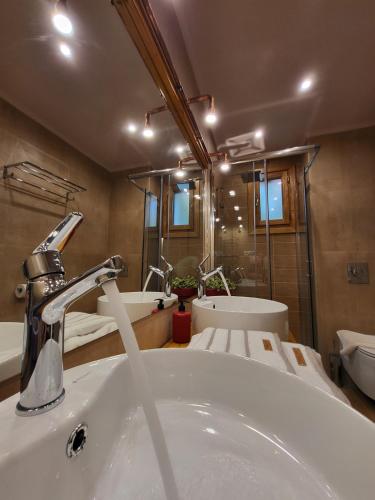a bathroom with a sink and two sinks and a mirror at BELLA VITA boutique hotel lefkada in Lefkada